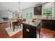 Open-concept kitchen with dark cabinets, granite countertops, and stainless steel appliances at 1307 Farm Branch Sw Dr, Concord, NC 28027
