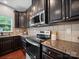 Modern kitchen featuring stainless steel appliances, granite countertops, and tiled backsplash at 1307 Farm Branch Sw Dr, Concord, NC 28027