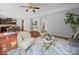 Open-concept living room with modern decor, plush seating, and seamless transition to dining area with hardwood floors at 1307 Farm Branch Sw Dr, Concord, NC 28027