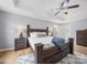 Cozy main bedroom with a tray ceiling, ceiling fan, and stylish decor at 1307 Farm Branch Sw Dr, Concord, NC 28027