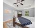 Bright main bedroom with a large window and a view into the main bathroom at 1307 Farm Branch Sw Dr, Concord, NC 28027