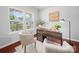 Bright home office featuring modern desk, stylish chairs, and hardwood floors bathed in sunlight at 1307 Farm Branch Sw Dr, Concord, NC 28027