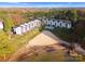 Aerial view of lakeside condo community with a private beach, swimming pool, pier and manicured grounds at 17811 Half Moon Ln # E, Cornelius, NC 28031