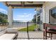 Outdoor balcony with black railings overlooking a sandy beach and lake view, ideal for relaxing and enjoying waterfront scenery at 17811 Half Moon Ln # E, Cornelius, NC 28031
