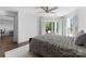 Bedroom with a ceiling fan and access to the balcony via shuttered sliding glass doors at 17811 Half Moon Ln # E, Cornelius, NC 28031