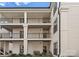 Three story condo with black railing balconies and lush landscaping at 17811 Half Moon Ln # E, Cornelius, NC 28031