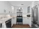 Bright kitchen featuring white cabinets, stainless steel appliances, and granite countertops at 17811 Half Moon Ln # E, Cornelius, NC 28031