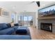 Cozy living room boasts a stone fireplace, blue sectional, and sliding glass doors to the outside patio at 17811 Half Moon Ln # E, Cornelius, NC 28031