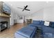 Open-concept living room with kitchen view, featuring modern decor and a comfortable blue sectional couch at 17811 Half Moon Ln # E, Cornelius, NC 28031