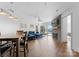 Spacious living room with fireplace, wood floors, water views, and balcony access at 17811 Half Moon Ln # E, Cornelius, NC 28031