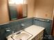 Bathroom featuring blue tiles, a sink, and a mirror at 1834 Sharonwood Ln, Rock Hill, SC 29732