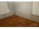 Bedroom with hardwood floors, two windows, and neutral wall color at 1834 Sharonwood Ln, Rock Hill, SC 29732