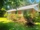 Brick house with green shutters and mature trees and manicured bushes at 1834 Sharonwood Ln, Rock Hill, SC 29732