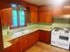 A retro kitchen with wooden cabinets, a white oven, and a green countertop at 1834 Sharonwood Ln, Rock Hill, SC 29732