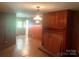 Open living area with hardwood floors, fireplace, and wood paneled walls at 1834 Sharonwood Ln, Rock Hill, SC 29732