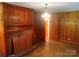 Cozy living room boasting a charming fireplace and knotty pine walls at 1834 Sharonwood Ln, Rock Hill, SC 29732