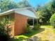 View of the side of the home showing the brick exterior and covered porch at 1834 Sharonwood Ln, Rock Hill, SC 29732