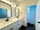 Bright bathroom featuring double vanity with quartz countertops and modern fixtures at 211 Surrey Oak Ln, Charlotte, NC 28216
