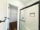 Beautiful bathroom featuring glass shower, black fixtures, and a walk-in closet at 211 Surrey Oak Ln, Charlotte, NC 28216