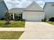 Charming single-Gathering home boasts a two-car garage, manicured lawn, and stylish exterior at 211 Surrey Oak Ln, Charlotte, NC 28216