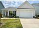 Charming single-Gathering home boasts a two-car garage, manicured lawn, and stylish exterior at 211 Surrey Oak Ln, Charlotte, NC 28216