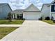 The exterior of this single-Gathering home has a large driveway and a two-car garage at 211 Surrey Oak Ln, Charlotte, NC 28216