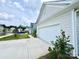 Garage view highlighting the attached two-car garage, concrete driveway, and manicured landscaping at 211 Surrey Oak Ln, Charlotte, NC 28216