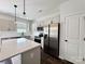 Modern kitchen featuring white cabinets, stainless steel appliances, and a quartz countertop island at 211 Surrey Oak Ln, Charlotte, NC 28216