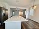 Bright, open kitchen featuring an island with quartz countertop and stainless steel appliances at 211 Surrey Oak Ln, Charlotte, NC 28216