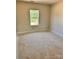 A serene bedroom showcasing a window with green outdoor views and ample natural light, ready for personalization at 3500 14Th Sw Ave, Hickory, NC 28602