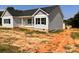 Side view of a cozy home with vinyl siding and an unfinished lawn, showcasing its quaint charm at 3500 14Th Sw Ave, Hickory, NC 28602