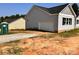 Detached garage with a white door, complementing the house's exterior, and a gravel driveway at 3500 14Th Sw Ave, Hickory, NC 28602