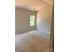 The unfinished bedroom features a window offering natural light and awaits personalized touches at 3506 14Th Sw Ave, Hickory, NC 28602