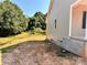 Side yard view of new construction home with concrete foundation and a partially fenced in yard at 3506 14Th Sw Ave, Hickory, NC 28602
