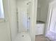 A pristine bathroom featuring a shower, vanity, and ample space at 405 S South St, Gastonia, NC 28052