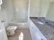 A well-lit bathroom featuring a tub-shower combo and granite vanity at 405 S South St, Gastonia, NC 28052