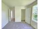 A bright bedroom with a neutral carpet, closet, and a window providing ample light at 405 S South St, Gastonia, NC 28052
