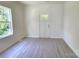 Cozy bedroom with light laminate floors, white walls, and a view of the outdoors at 405 S South St, Gastonia, NC 28052