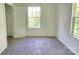 A bright bedroom with carpet, featuring a closet and windows offering a pleasant view at 405 S South St, Gastonia, NC 28052