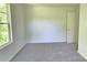 A cozy bedroom with a neutral carpet and a large window providing ample light at 405 S South St, Gastonia, NC 28052