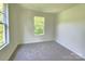 An empty bedroom with carpet and two large windows that brighten the space at 405 S South St, Gastonia, NC 28052