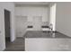 Modern kitchen with white cabinetry, granite countertops, and stainless steel sink at 405 S South St, Gastonia, NC 28052