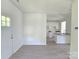 Open living area with light laminate floors that lead to a modern kitchen at 405 S South St, Gastonia, NC 28052