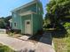 Home's rear exterior featuring matching green siding with a back door at 405 S South St, Gastonia, NC 28052