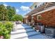 Brick home featuring back porch and patio with awning and green landscaped backyard at 4121 Dover St, Claremont, NC 28610