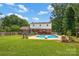 Large backyard boasts a pool, patio, and ample green space, perfect for outdoor activities and entertaining at 4121 Dover St, Claremont, NC 28610