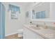 Bright bathroom features white cabinets, light-colored walls, and tile flooring at 4121 Dover St, Claremont, NC 28610