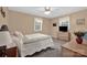 Light beige bedroom features two windows, ceiling fan, and soft, neutral finishes at 4121 Dover St, Claremont, NC 28610