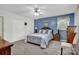Cozy bedroom with soft carpet, blue accent wall, and ample natural light at 4121 Dover St, Claremont, NC 28610