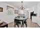 Charming dining room with modern lighting, tile floors and adjacent to the open-concept kitchen at 4121 Dover St, Claremont, NC 28610